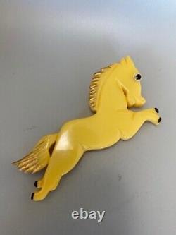 JL Foltz Carved Yellow Bakelite Equestrian Leaping Horse Glass Eye Brooch Pin