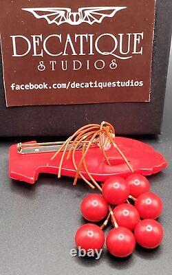 Red Bakelite Hand Holding 8 Dangling Beads Cherries Brooch