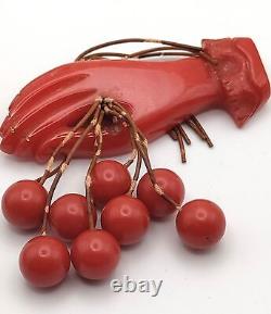 Red Bakelite Hand Holding 8 Dangling Beads Cherries Brooch