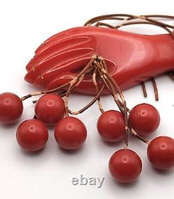 Red Bakelite Hand Holding 8 Dangling Beads Cherries Brooch