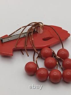 Red Bakelite Hand Holding 8 Dangling Beads Cherries Brooch