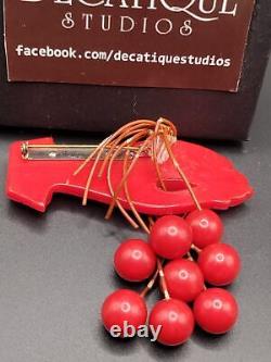 Red Bakelite Hand Holding 8 Dangling Beads Cherries Brooch