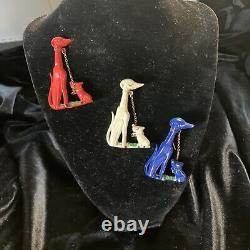 Trio of vintage Bakelite/celluloid dog pins