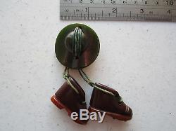 Vintage Rare Bakelite Pin of a Studded Boots hanging from a Marbled Green Hat