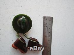 Vintage Rare Bakelite Pin of a Studded Boots hanging from a Marbled Green Hat