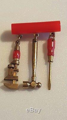 Vintage red bakelite bar pin brooch with three dangling miniature tools