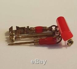 Vintage red bakelite bar pin brooch with three dangling miniature tools